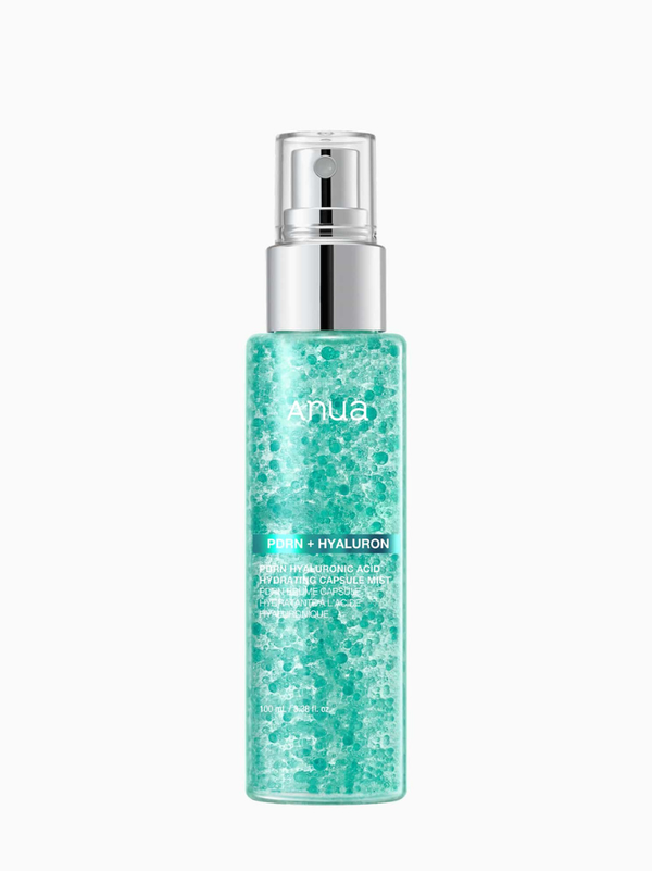 Anua PDRN Hyaluronic Acid Hydrating Capsule Mist 100ml bottle featuring visible emerald-hued oil capsules for deep hydration and radiance.