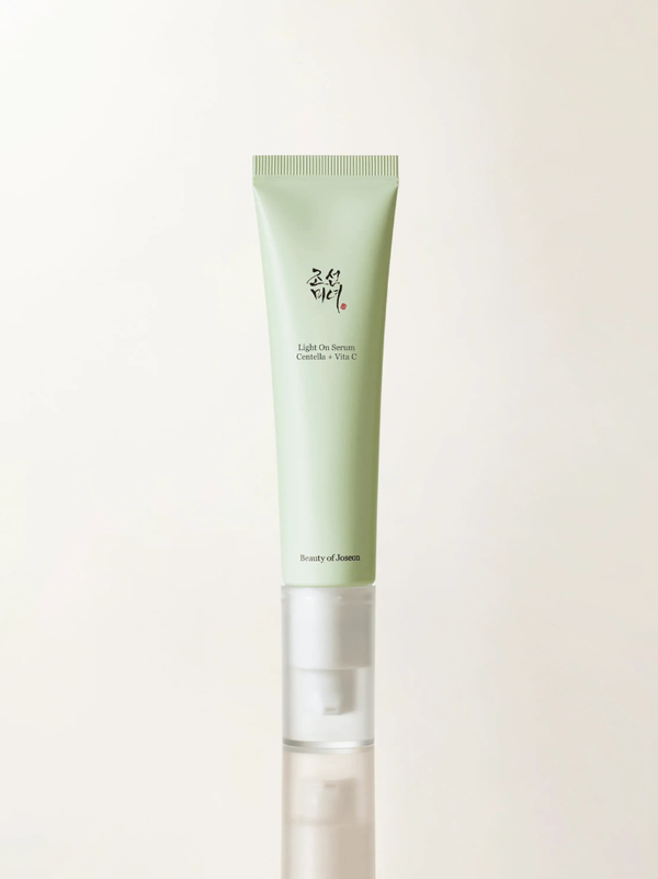 Beauty of Joseon Light On Serum Centella + Vita C sleek pump bottle on a minimalist stone background.