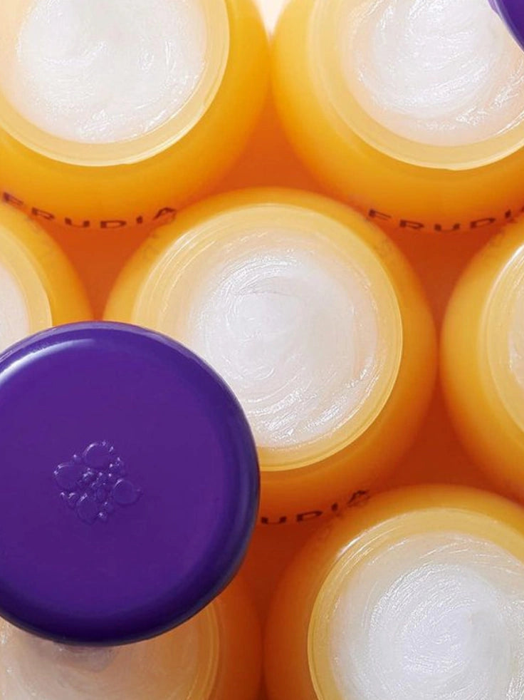 Collection of Frudia Blueberry Hydrating Honey Lip Balm jars, offering luxurious lip care.