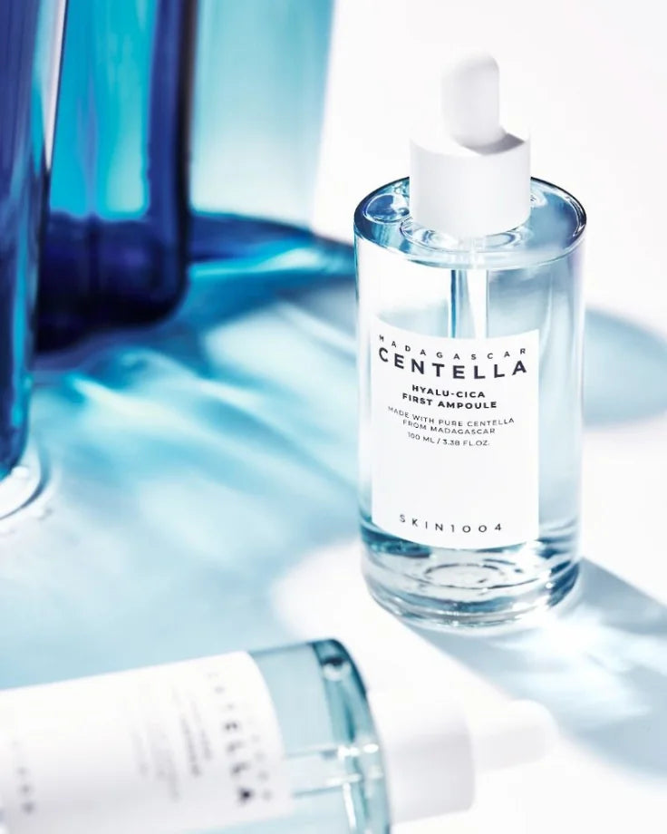 The SKIN1004 Hyalu-Cica Ampoule bottle and packaging box. Features 5-layer Hyaluronic Acid and is EWG Green Grade certified.