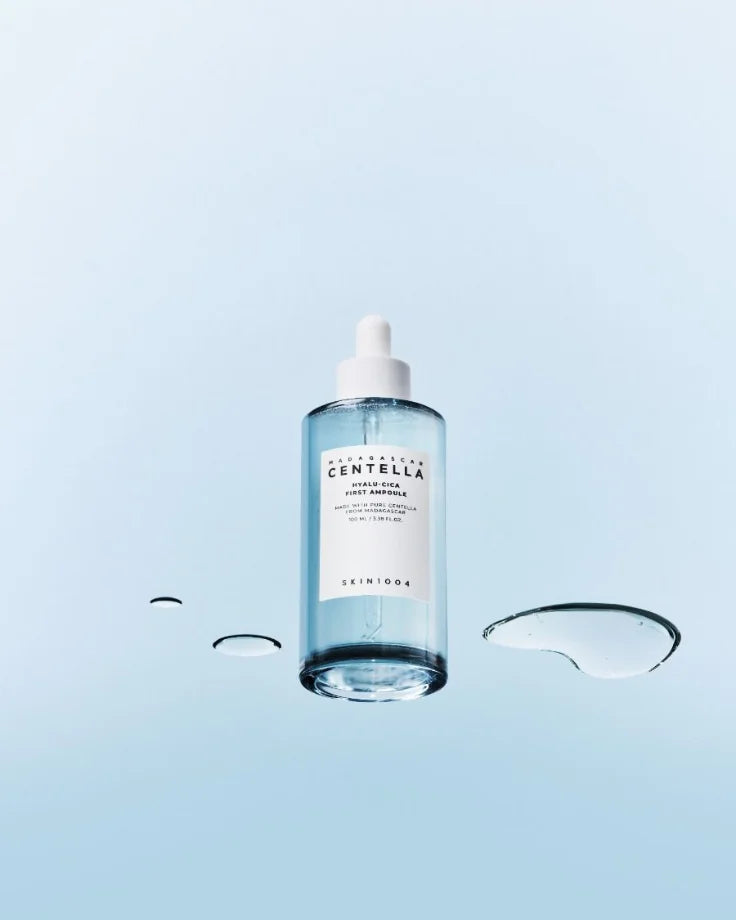 Studio shot of the SKIN1004 First Ampoule bottle, highlighting the label and the Hyalu-Cica complex. Essential moisture-boosting serum.