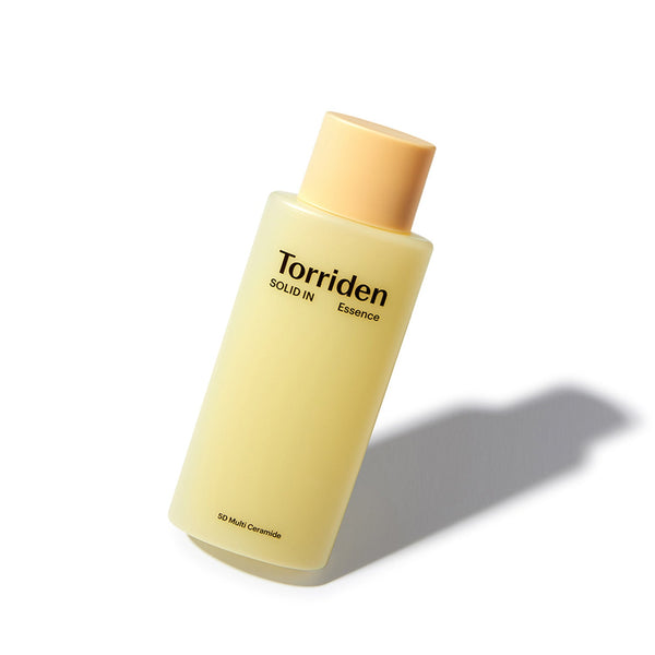 Torriden SOLID-IN Essence 100ml aesthetic bottle with its signature pale yellow milky texture.